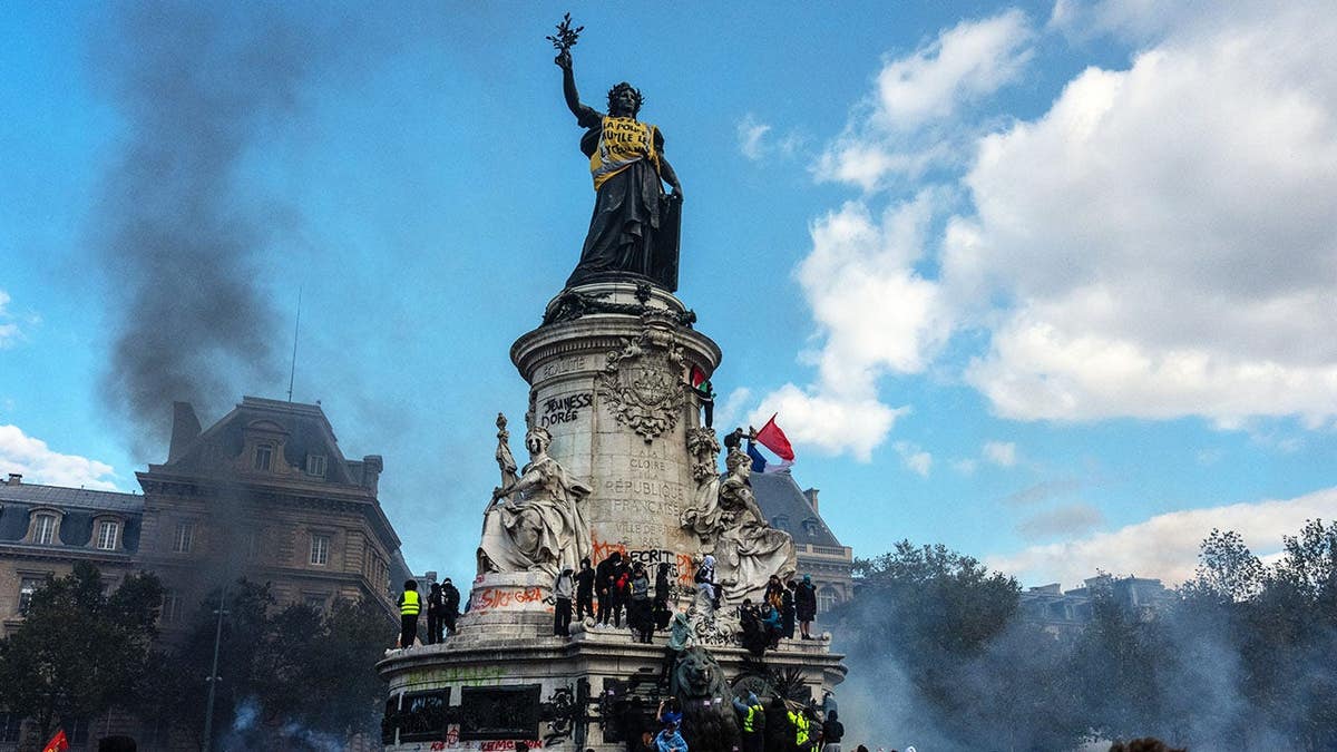 Yellow vest on the statue of Marianne during demonstrations in Paris, France.