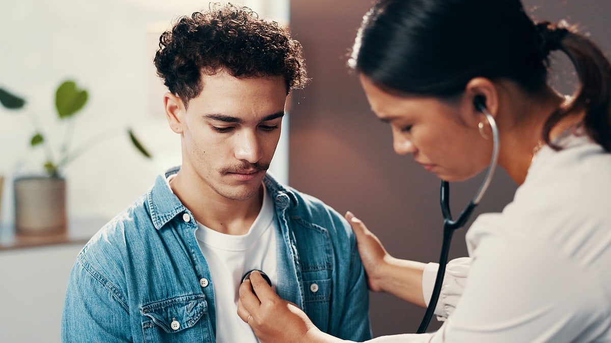 man having heart checked by doctor