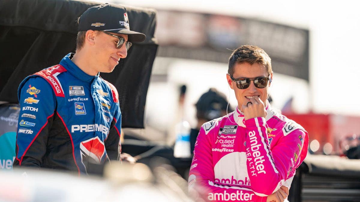 Zane Smith talks with Carson Hocevar before qualifying at Texas Motor Speedway.