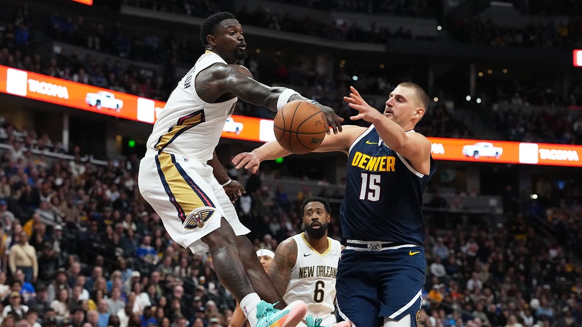 Zion Williamson blocks Nikola Jokić's shot during an NBA game in Denver.
