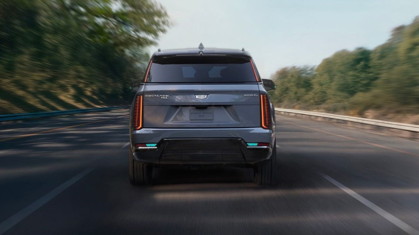 General Motors' Cadillac Escalade IQ drives down a road.