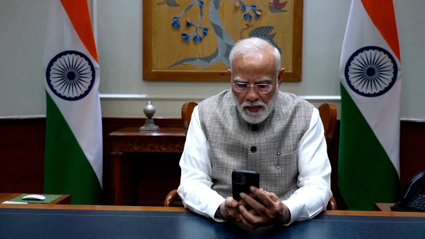 Indian Prime Minister Narendra Modi speaks to FlyDubai pilot Capt. Smit Machchhar
