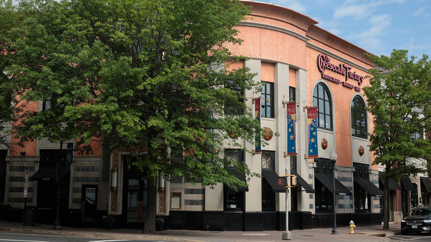 Cheesecake Factory on tree-lined street in Arlington, VA.