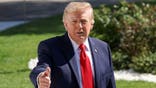 Trump gives a thumbs-up gesture.