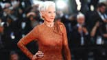 Maye Musk in a sparkling orange dress posing for the cameras.