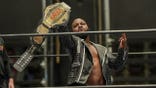 Michael Fain holds the belt