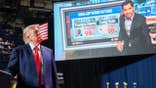 President Donald Trump watches a video onstage during a campaign rally in San Antonio, Texas