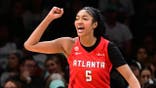Angel Reese #5 celebrates during a WNBA semifinal game at Barclays Center Arena.