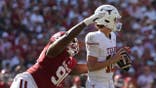 Arch Manning is tackled by Trent Wilson during the first half at Cotton Bowl.