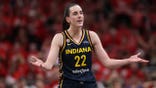 Caitlin Clark #22 reacts after being charged with a foul during an Indiana Fever WNBA Playoffs game.