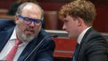 Carter Eslick speaks with his lawyer