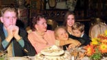 Eric Trump sits at a table with family members during Thanksgiving dinner.