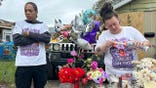 Julius Windham visits a memorial outside a home in Erie, Pa., where a shooting occurred.