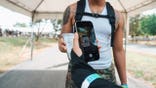 Festival goers scan QR code tickets on smartphones at a music festival entrance gate.