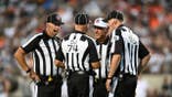 Game officials Jeff Seeman, John Hussey, Tony Michalek and Derrick Bowers talk on the field during the Pro Football Hall of Fame Game.