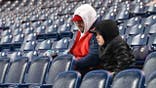 Fans sit in the stands after game postponement at Progressive Field.