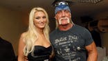 Brooke Hogan and Hulk Hogan pose together at an event.