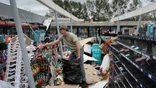 A man cleans up a store after Hurricane Isaias passed through the area on October 10, 2026, in Milton, Florida.