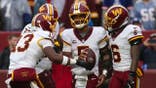 Jayden Daniels celebrates with Washington Commanders teammates after scoring a rushing touchdown.