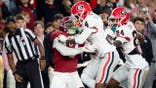 KJ Bolden, Georgia defensive back, hits Rico Scott, Alabama wide receiver, before the ball arrives.