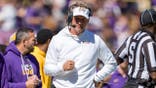 Lane Kiffin reacts on the sideline during a football game.