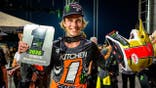 Levi Kitchen holds his 2026 Monster Energy SMX 250 Class World Championship trophy