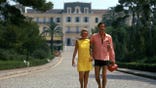 Louis Jourdan and his wife Quiquie sit together outdoors at a hotel on the French Riviera.