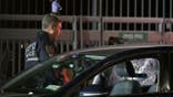 image shows car with smashed window