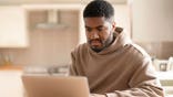 Young man works on laptop