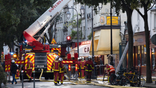 Firefighters stand near the cordoned-off Marche des Enfants Rouges in Paris.
