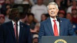 President Donald Trump and Senator Roger Marshall stand together at a campaign event in Park City, Kansas.