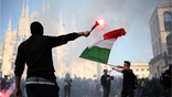 Demonstrators light flares during an anti-government protest organized by the Italia in Piazza movement, at Piazza Duomo in Milan, on October 17, 2026.