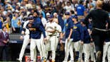 Milwaukee Brewers members celebrate on the field after winning Game 1 of the NLCS.