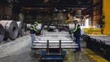 Employees work in a finishing mill at the NLMK Pennsylvania plant in Farrell, Pennsylvania.