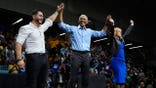 Barack Obama, Abdul El-Sayed and Jocelyn Benson raise their hands at a campaign event.