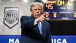 President Donald Trump takes the stage at a podium during a campaign rally in Vandalia, Ohio.