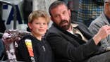 Ben Affleck and Samuel Garner Affleck seated at a basketball game.