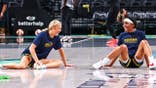 Sophie Cunningham and Sydney Colson warm up before a WNBA game.