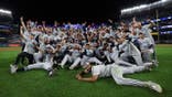 Tampa Bay Rays players pose for a photo at Yankee Stadium after winning Game 3 of the ALDS.