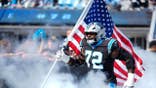 Taylor Moton walks onto the field in his Panthers uniform before the game.