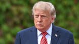 President Donald Trump looks toward media while exiting Áras an Uachtaráin in Dublin, Ireland.