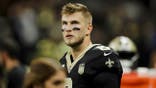 Tyler Shough stands on the sideline during a Saints game.