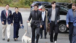 Clavicular walks a dog before heading to court.