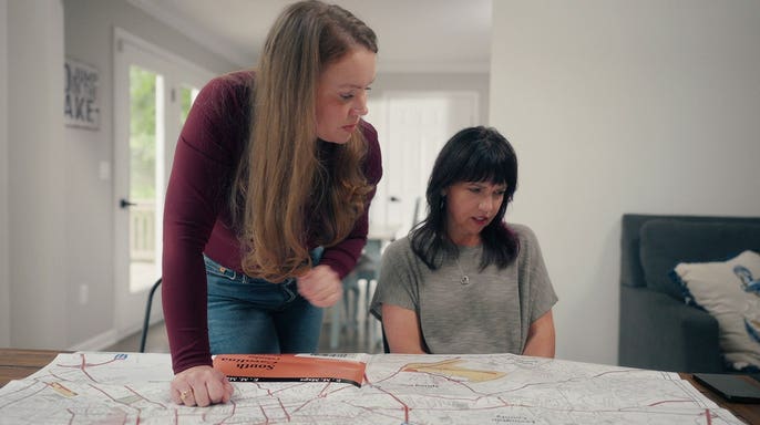 Kara Robinson Chamberlain and Bonnie Lou Gower looking at a map.