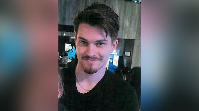 Close-up photo of missing 24-year-old Phoenix Phillips wearing a black shirt.