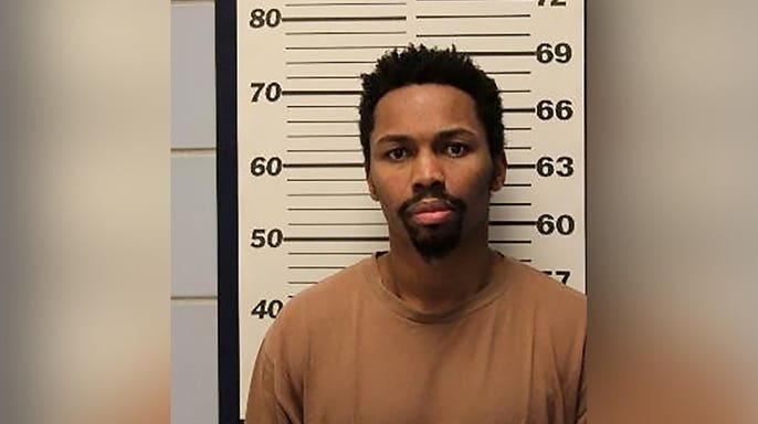 Mugshot of shooting suspect Jerrell Jackson standing in front of a height chart