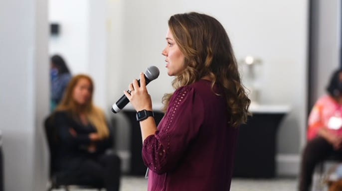 Kara Robinson Chamberlain giving a speech.