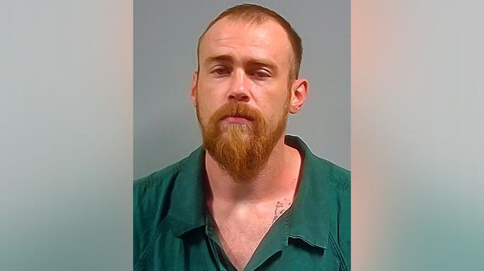 Dustin Kelley is pictured following his arrest in Escambia County, Florida.