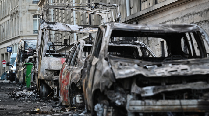 A photograph shows wreckages of burnt down vehicles in the street of Paris on October 18, 2026 a day after nationwide protests against the 