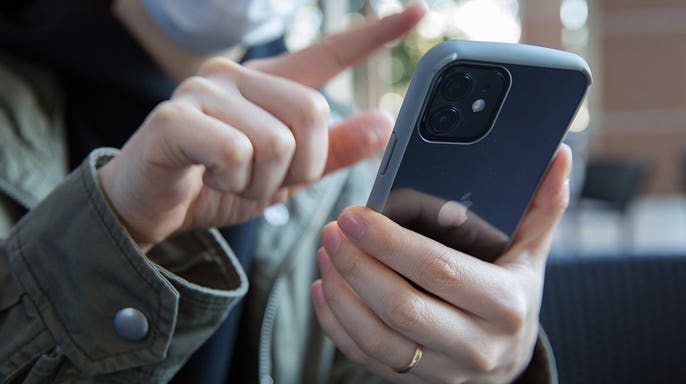 Person typing on their smartphone.